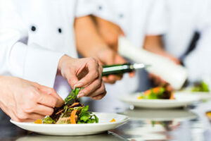 Cooking apprentices prepare dishes